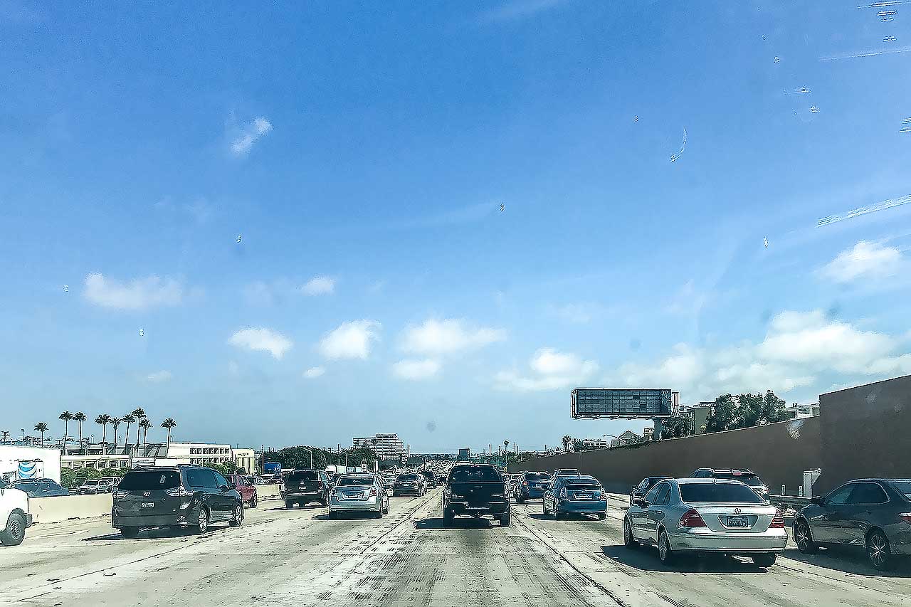 Traffico su una grande autostrada a più corsie a Los Angeles in una giornata di sole.