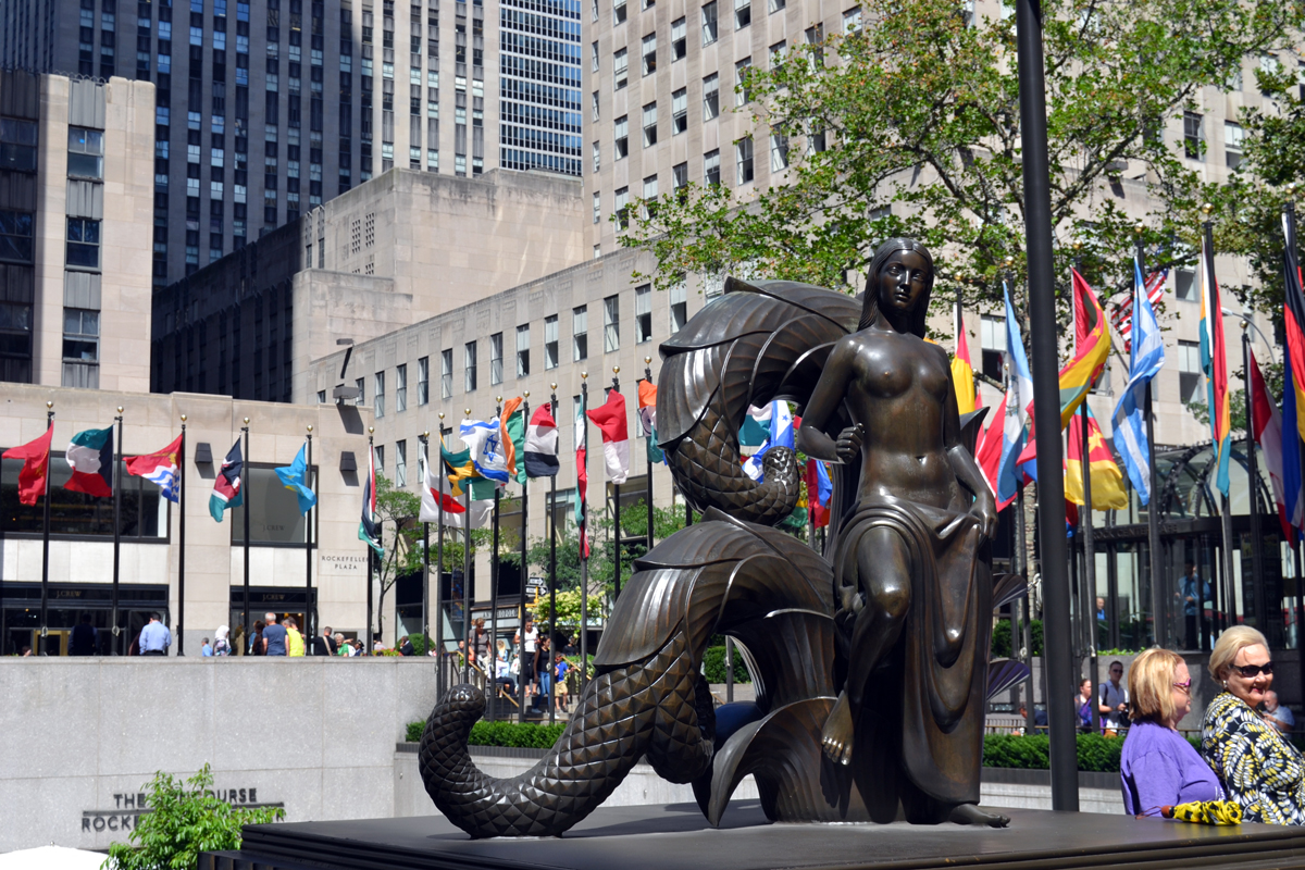 Rzeźba młodej kobiety z mitycznym zwierzęciem na tle placu Rockefeller Center