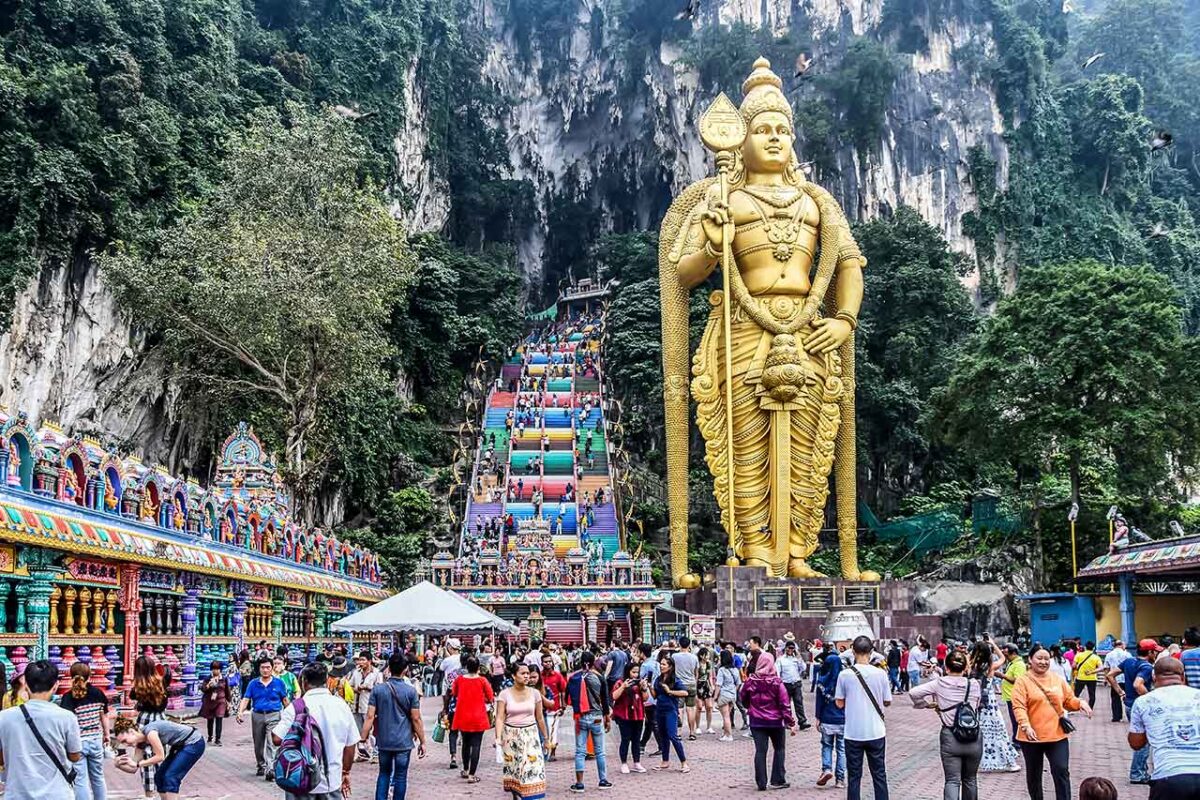 L'imponente statua dorata di Lord Murugan davanti alle scale colorate delle Batu Caves.